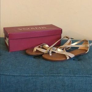 Bone and gold colored sandals